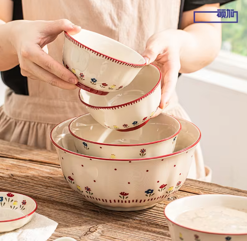 Set of ceramic bowls with floral patterns on a wooden surface
